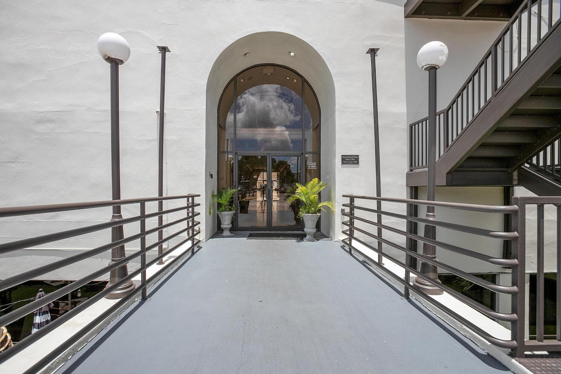 Arched glass entryway and pedestrian bridge leading into New York Plaza